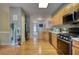 Bright kitchen with stainless steel appliances, hardwood floors, and an open layout to the hallway at 2160 Dillard Xing, Tucker, GA 30084