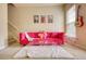 Bright living room with a plush pink sofa, clear coffee table, and stylish decor creating a modern, inviting space at 2160 Dillard Xing, Tucker, GA 30084