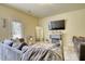 Comfortable living room with neutral tones, fireplace, and large-screen TV at 2160 Dillard Xing, Tucker, GA 30084