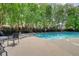 A shared pool area, featuring comfortable loungers and lush, green landscaping at 2160 Dillard Xing, Tucker, GA 30084