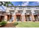 Three-story townhouse showcasing individual balconies, rear patios, and lawn at 2160 Dillard Xing, Tucker, GA 30084