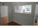 Dining room with hardwood floors leads to a bright white kitchen at 2381 Eastway Rd, Decatur, GA 30033