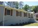 Side view of painted brick home with wood shutters and a screened porch at 2381 Eastway Rd, Decatur, GA 30033