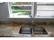 Stainless steel kitchen sink, and granite countertops under a bright window at 2381 Eastway Rd, Decatur, GA 30033