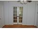 Living room with hardwood floors and a pair of french doors at 2381 Eastway Rd, Decatur, GA 30033