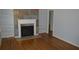 Bright living room featuring hardwood flooring, a fireplace with custom shelving at 2381 Eastway Rd, Decatur, GA 30033