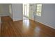 Spacious room featuring shiny hardwood flooring, natural light and a front entrance door at 2381 Eastway Rd, Decatur, GA 30033