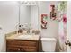 Cozy bathroom with dark vanity, tan granite, large mirror, and shower/tub combo at 3099 Regency Park Dr, Lithonia, GA 30038