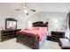 Bedroom with decorative headboard, pink bedding, and ceiling fan at 3099 Regency Park Dr, Lithonia, GA 30038