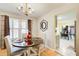 Dining area features a round table, window with blinds, and an open view into the kitchen at 3099 Regency Park Dr, Lithonia, GA 30038