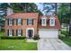 Charming brick home featuring black shutters, dormer windows, and a well-manicured lawn at 3099 Regency Park Dr, Lithonia, GA 30038