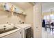 Convenient laundry room with washer, dryer, and storage shelving, located off the kitchen and breakfast area at 3099 Regency Park Dr, Lithonia, GA 30038