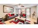 Cozy living room with hardwood floors, a ceiling fan, and neutral-toned furniture with red accents at 3099 Regency Park Dr, Lithonia, GA 30038