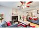 Comfortable living area featuring a fireplace, hardwood floors, and neutral-toned furniture with red accents at 3099 Regency Park Dr, Lithonia, GA 30038