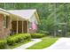 Classic brick home detail featuring an American flag, rocking chairs, and manicured landscaping at 544 W Macedonia Church Rd, Oxford, GA 30054