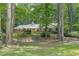 Secluded brick home nestled amongst mature trees providing privacy and a sense of tranquility at 544 W Macedonia Church Rd, Oxford, GA 30054