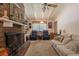 Cozy living room with a brick fireplace, exposed ceiling beams, and comfortable seating at 544 W Macedonia Church Rd, Oxford, GA 30054