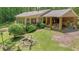 Back of house featuring brick exterior, sunroom and deck with a serene, wooded yard at 544 W Macedonia Church Rd, Oxford, GA 30054