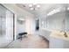 A luxurious primary bathroom showcases white cabinets, a vanity area, and a glass enclosed shower with natural light at 1481 Highway 85 Connector, Brooks, GA 30205