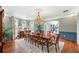 Formal dining room showcasing a grand chandelier, large table with seating for ten, wallpaper and large windows at 1481 Highway 85 Connector, Brooks, GA 30205