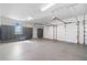 Spacious three-car garage with epoxy flooring and ample storage cabinets at 1481 Highway 85 Connector, Brooks, GA 30205
