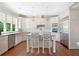 Bright kitchen features white cabinets, stainless steel appliances, granite countertops, and a center island with bar stool seating at 1481 Highway 85 Connector, Brooks, GA 30205