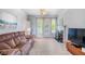 Cozy living room with a plush couch, fireplace, and large windows at 1481 Highway 85 Connector, Brooks, GA 30205