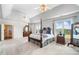 Bright primary bedroom features a four-poster bed, plush carpeting, and access to a private ensuite bathroom at 1481 Highway 85 Connector, Brooks, GA 30205