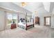Spacious main bedroom with tray ceilings, a four-poster bed, soft carpet, and lots of natural light at 1481 Highway 85 Connector, Brooks, GA 30205