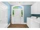 Mud room featuring a chandelier, welcome sign, laundry, and bright front door at 1481 Highway 85 Connector, Brooks, GA 30205