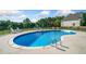 Beautiful kidney-shaped pool, surrounded by a concrete patio and lounge chairs, perfect for summer relaxation at 1481 Highway 85 Connector, Brooks, GA 30205