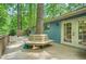 View of the expansive deck featuring built-in seating around a mature tree, and access to the home's interior at 2336 Vistamont Dr, Decatur, GA 30033