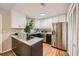 Modern kitchen with white cabinets, stainless steel appliances, and an island with a granite countertop at 2336 Vistamont Dr, Decatur, GA 30033