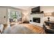 Bright living room with a stone fireplace, hardwood floors, bay window, and comfortable seating at 2336 Vistamont Dr, Decatur, GA 30033