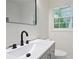Bathroom with black faucet, mirror, grey vanity, and white counter at 3480 Mount Olive Rd, Atlanta, GA 30344