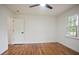 Bright bedroom with hardwood floors, modern ceiling fan, and white door at 3480 Mount Olive Rd, Atlanta, GA 30344