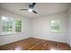 Bright bedroom features hardwood floors, fresh white walls, and a modern ceiling fan at 3480 Mount Olive Rd, Atlanta, GA 30344