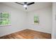 Sun-filled bedroom with hardwood floors and large windows showcasing lush greenery at 3480 Mount Olive Rd, Atlanta, GA 30344
