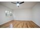 A well-lit bedroom with a modern fan and gleaming hardwood floors at 3480 Mount Olive Rd, Atlanta, GA 30344