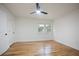 Bright bedroom with hardwood floors, white walls, and a modern ceiling fan fixture at 3480 Mount Olive Rd, Atlanta, GA 30344