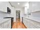 Kitchen featuring white cabinets, stainless appliances, granite countertops, and hardwood floors at 3480 Mount Olive Rd, Atlanta, GA 30344