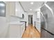 Galley kitchen with stainless appliances, white cabinets, and hardwood floors at 3480 Mount Olive Rd, Atlanta, GA 30344
