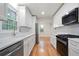 Bright kitchen with white cabinets, stainless appliances, hardwood floors, and granite countertops at 3480 Mount Olive Rd, Atlanta, GA 30344