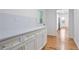 White cabinets and countertops complement the laundry room featuring a stackable washer and dryer at 3480 Mount Olive Rd, Atlanta, GA 30344