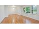 Living room with hardwood floors, fresh paint, updated lighting, and large windows at 3480 Mount Olive Rd, Atlanta, GA 30344