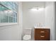 Powder room featuring modern vanity, toilet, and large window at 3480 Mount Olive Rd, Atlanta, GA 30344