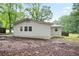Rear exterior of the home featuring new siding and updated windows, nestled on a shady lot at 3480 Mount Olive Rd, Atlanta, GA 30344