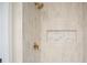 Detailed closeup of shower with intricate tile work, niche, and gold fixtures at 3480 Mount Olive Rd, Atlanta, GA 30344