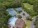 Aerial view of pool, tennis courts, and recreation fields surrounded by lush green trees at 350 Medridge Dr, Johns Creek, GA 30022