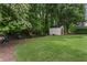 Large backyard with trees and a shed, offering plenty of space for outdoor activities at 350 Medridge Dr, Johns Creek, GA 30022